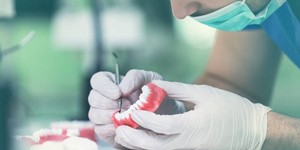 Lab technician crafting denture