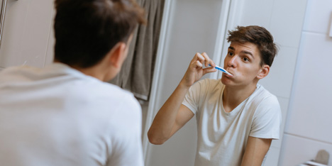 man brushing teeth