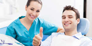 Man in dental chair giving thumbs up