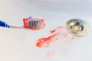 A toothbrush with blood on it.