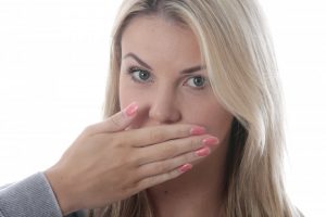 woman covering mouth